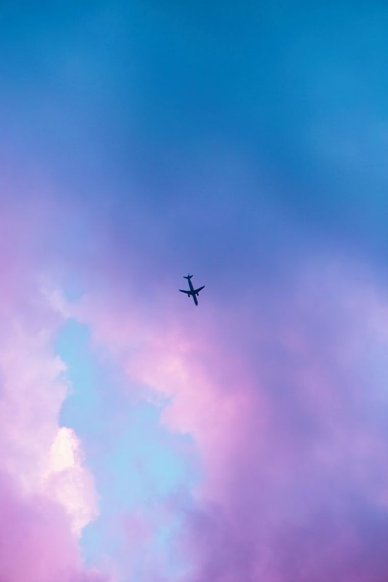 a large airplane flying high up in the air